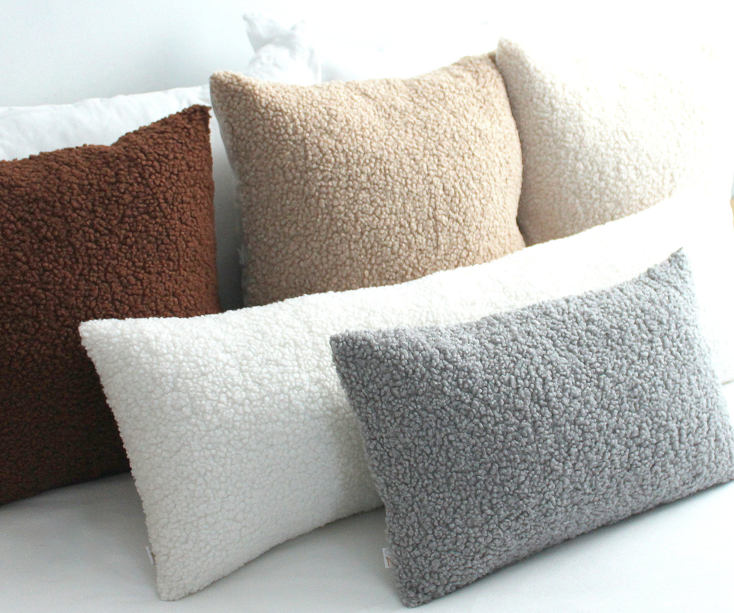 Create a cozy look to your space with this Light Grey Cozy Teddy Boucle Throw Pillow Cover. The classic texture adds a warm and inviting touch to your sofa or bed. Comfortable to touch makes it perfect for snuggling up with!